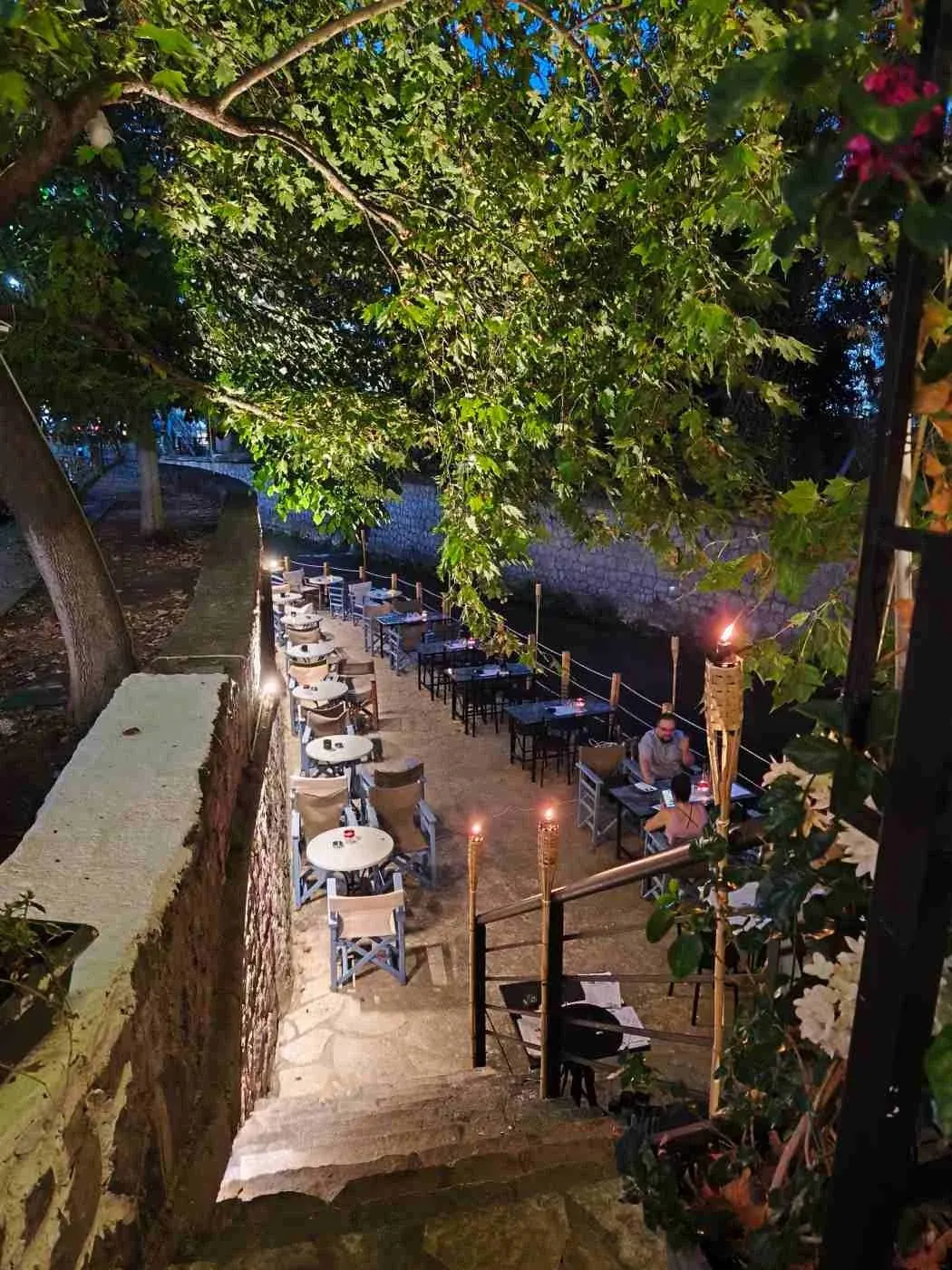 Restaurant tables beside the river in Livadia