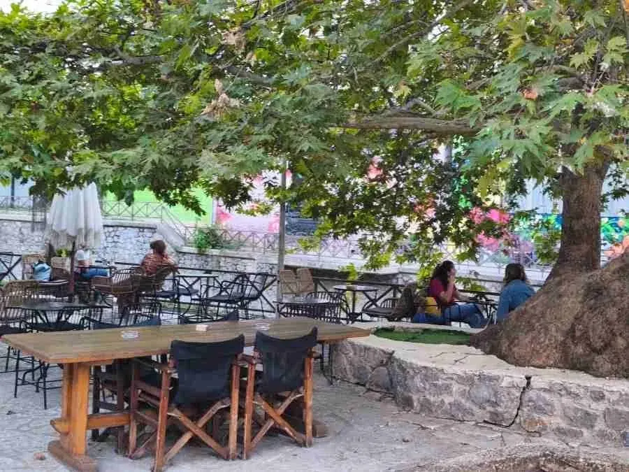 Cafe tables beside the river in Livadia
